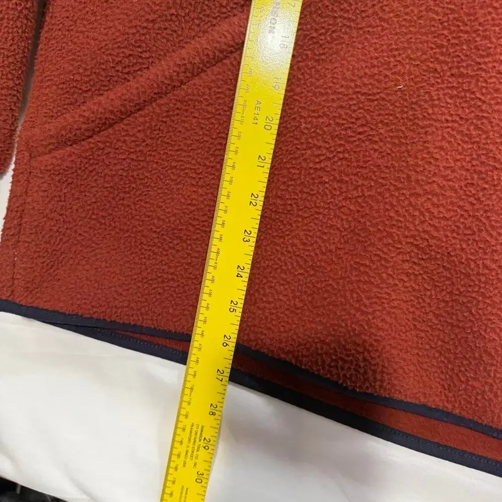 The North Face orange fleece hoodie with navy blue trim, size M